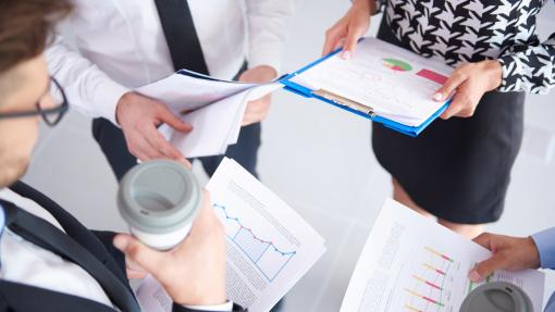 Professionals analysing documents and charts, representing support for companies in navigating funding opportunities and investment strategies.