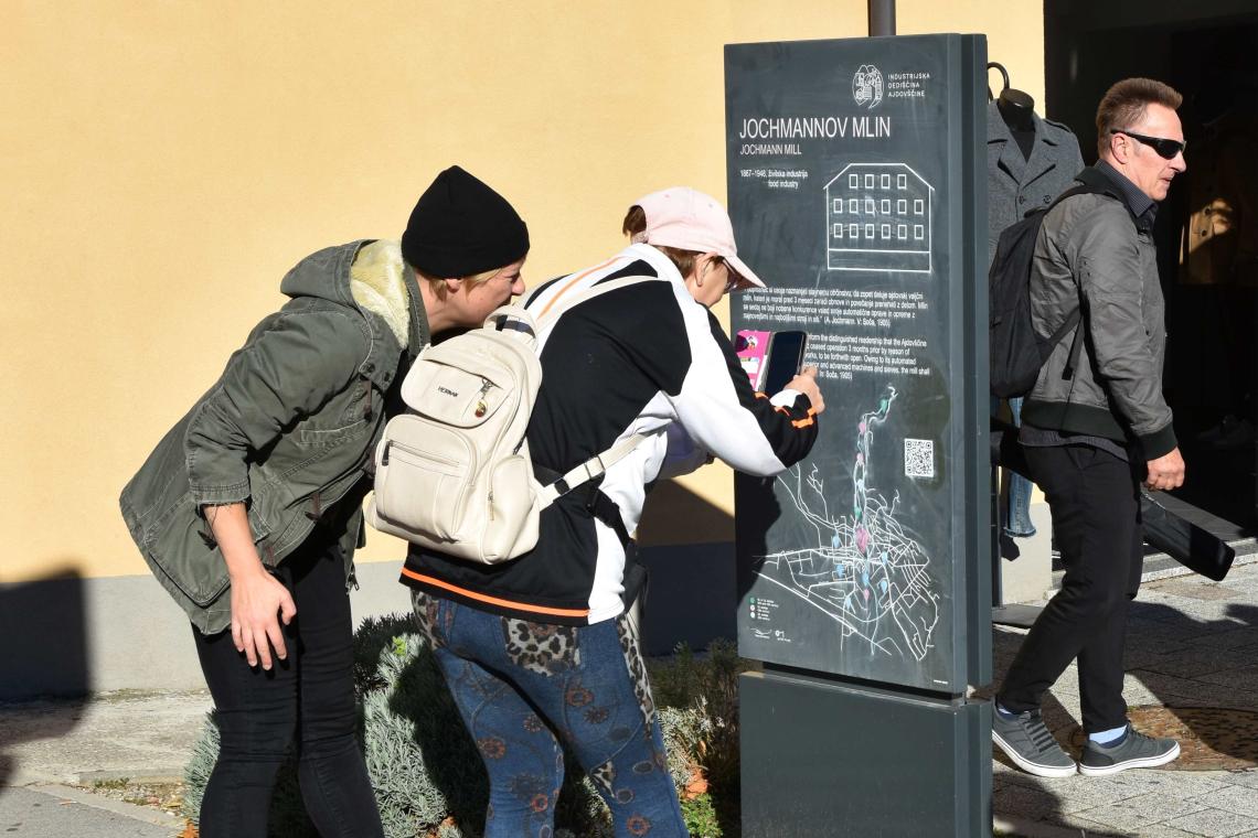 Visitors scanning QR code on info bord of Jochmann Mill